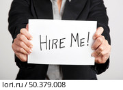 Business woman holding a card board with the text message "Hire me" Стоковое фото, агентство Ingram Publishing / Фотобанк Лори