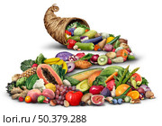Cornucopia horn object full of fresh fruit and vegetables on a white background as a rustic traditional wicker or weaved basket with healthy nutritious agricultural produce. Стоковое фото, агентство Ingram Publishing / Фотобанк Лори