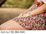 Picture of a young girl in the park showing only part of the body. Стоковое фото, агентство Ingram Publishing / Фотобанк Лори