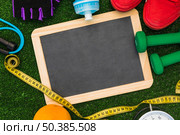top view blank slate surrounded with sports equipment turf. Стоковое фото, агентство Ingram Publishing / Фотобанк Лори