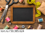top view scissors with measuring tape chalkboard. Стоковое фото, агентство Ingram Publishing / Фотобанк Лори