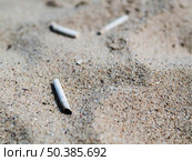 OLYMPUS DIGITAL CAMERA. used cigarette butts sand beach. Стоковое фото, агентство Ingram Publishing / Фотобанк Лори