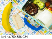 banana lying near lunchbox. Стоковое фото, агентство Ingram Publishing / Фотобанк Лори
