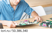 close up hardware engineer repairing motherboard. Стоковое фото, агентство Ingram Publishing / Фотобанк Лори