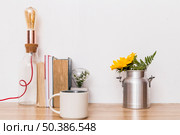 cup flowers tin can books lamp table. Стоковое фото, агентство Ingram Publishing / Фотобанк Лори
