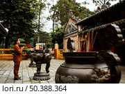 side view man praying temple with incense. Редакционное фото, агентство Ingram Publishing / Фотобанк Лори