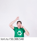 thoughtful man holding light bulb his head. Стоковое фото, агентство Ingram Publishing / Фотобанк Лори