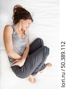 Young girl in pain with PMS, Premenstural Syndrome. Стоковое фото, агентство Ingram Publishing / Фотобанк Лори