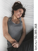 Young girl in pain with PMS, Premenstural Syndrome. Стоковое фото, агентство Ingram Publishing / Фотобанк Лори