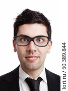 Funny portrait of a young businessman with crooked eyes wearing nerd glasses. Стоковое фото, агентство Ingram Publishing / Фотобанк Лори