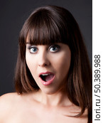 Portrait of a lovely woman with a astonish expression against a grey background . Стоковое фото, агентство Ingram Publishing / Фотобанк Лори