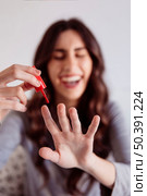 blurred woman painting nails. Стоковое фото, агентство Ingram Publishing / Фотобанк Лори
