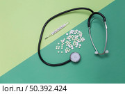 high angle view medicines thermometer stethoscope dual colored background. Стоковое фото, агентство Ingram Publishing / Фотобанк Лори