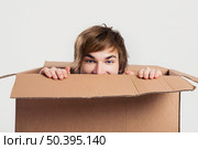 Portrait of a handsome young man inside a cardbox. Стоковое фото, агентство Ingram Publishing / Фотобанк Лори
