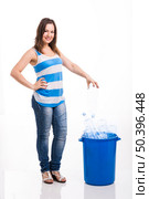 Beautiful young woman doing recycling, isolated over white background. Стоковое фото, агентство Ingram Publishing / Фотобанк Лори