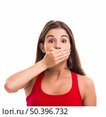 Beautiful young woman covering the mouth with her hand, isolated over a white background. Стоковое фото, агентство Ingram Publishing / Фотобанк Лори