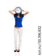Causal young woman holding a clock, isolated over a white background. Стоковое фото, агентство Ingram Publishing / Фотобанк Лори