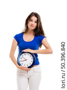 Causal young woman holding a clock, isolated over a white background. Стоковое фото, агентство Ingram Publishing / Фотобанк Лори