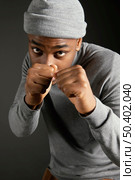 male wearing cap with fists clenched. Стоковое фото, агентство Ingram Publishing / Фотобанк Лори