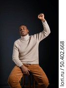 portrait young african man with hand rised. Стоковое фото, агентство Ingram Publishing / Фотобанк Лори