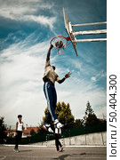 A basketball player drives to the hoop for a slam . Стоковое фото, агентство Ingram Publishing / Фотобанк Лори