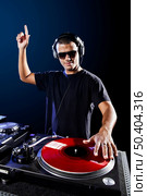 Dj playing disco electro music in a concert. Стоковое фото, агентство Ingram Publishing / Фотобанк Лори