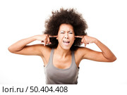 Beautiful Afro-American woman doing a silence gesture with fingers on the ears, isolated on white. Стоковое фото, агентство Ingram Publishing / Фотобанк Лори
