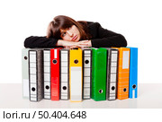 Exhausted woman in the office resting over  the folders, isolated on white background. Стоковое фото, агентство Ingram Publishing / Фотобанк Лори