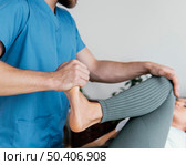 osteopathic doctor checking female patient s leg movement. Стоковое фото, агентство Ingram Publishing / Фотобанк Лори