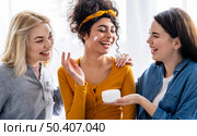 portrait happy women laughing playing with moisturizer. Стоковое фото, агентство Ingram Publishing / Фотобанк Лори