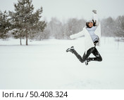 front view woman jumping air outdoors winter. Стоковое фото, агентство Ingram Publishing / Фотобанк Лори