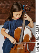 young girl learning how play cello. Стоковое фото, агентство Ingram Publishing / Фотобанк Лори