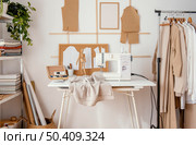 front view tailoring studio with sewing machine garments. Стоковое фото, агентство Ingram Publishing / Фотобанк Лори
