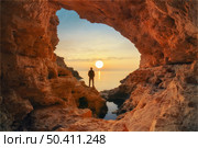 Man in sea grotto. Sea cave mainsail nature landsacpe. Стоковое фото, агентство Ingram Publishing / Фотобанк Лори