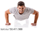 Man making pushups in studio, isolated over a white background. Стоковое фото, агентство Ingram Publishing / Фотобанк Лори