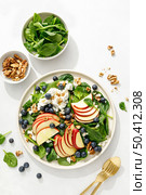 Apple and spinach fresh sweet fruit salad with blueberry, cheese cottage and walnuts, top view. Стоковое фото, агентство Ingram Publishing / Фотобанк Лори