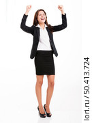 Beautiful and happy hispanic business woman with arms up, isolated over a white background. Стоковое фото, агентство Ingram Publishing / Фотобанк Лори