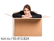Happy business woman appear inside a big card box, isolated over white background . Inside the box. Стоковое фото, агентство Ingram Publishing / Фотобанк Лори