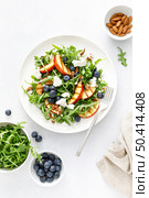 Peach, blueberry and arugula fresh fruit salad with cheese and almond nuts, top view. Стоковое фото, агентство Ingram Publishing / Фотобанк Лори