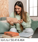 medium shot woman holding brick. Стоковое фото, агентство Ingram Publishing / Фотобанк Лори