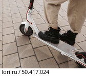 young woman riding electric scooter 23. Стоковое фото, агентство Ingram Publishing / Фотобанк Лори