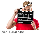 Portrait of a handsome young man wolding a clapboard. Стоковое фото, агентство Ingram Publishing / Фотобанк Лори