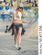 Beautiful and sexy street girl with her skateboard. Стоковое фото, агентство Ingram Publishing / Фотобанк Лори