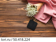 black speech prop gypsophila inside ice cream cone pink textile against wooden textured backdrop. Стоковое фото, агентство Ingram Publishing / Фотобанк Лори