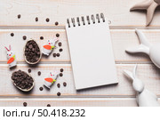 blank spiral notepad easter eggs with choco chips bunnies wooden backdrop. Стоковое фото, агентство Ingram Publishing / Фотобанк Лори