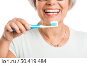 Portrait of a happy old woman brushing her teeth. Стоковое фото, агентство Ingram Publishing / Фотобанк Лори