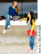 Beautiful and happy teenage students in the school. Стоковое фото, агентство Ingram Publishing / Фотобанк Лори