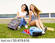 Beautiful and happy teenage students in the school. Стоковое фото, агентство Ingram Publishing / Фотобанк Лори