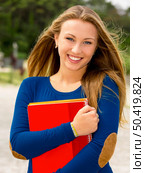 Beautiful and happy teenager student in the school. Стоковое фото, агентство Ingram Publishing / Фотобанк Лори