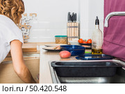female opening cupboard sink. Стоковое фото, агентство Ingram Publishing / Фотобанк Лори